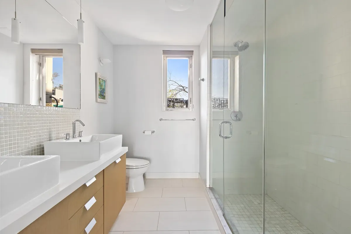 Bathroom with patterned tile and brass-toned fixtures at Casa Vizcaya 3E