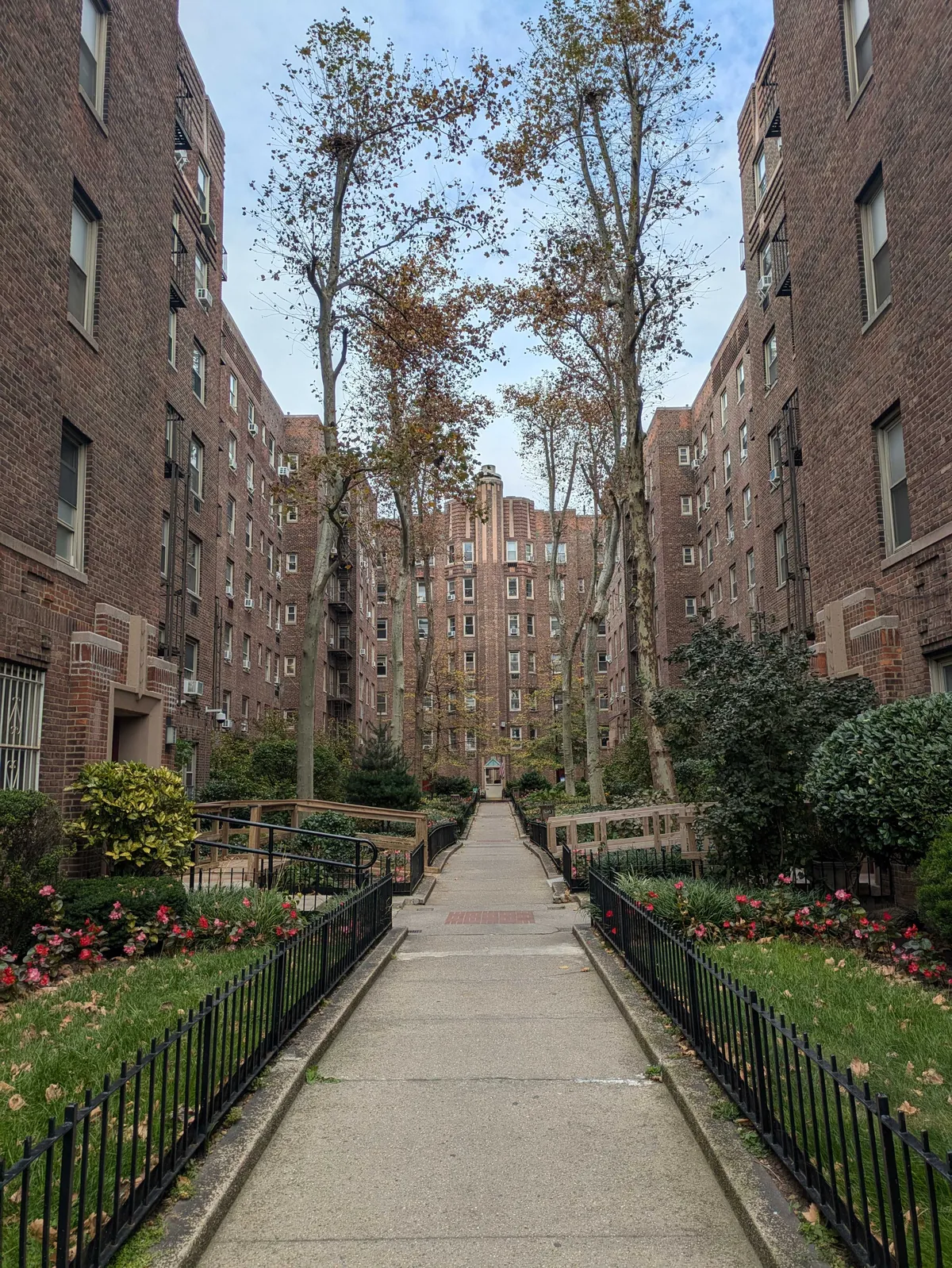 Brick co-op exteriors and landscaped courtyard at Celtic Park in Sunnyside, Queens