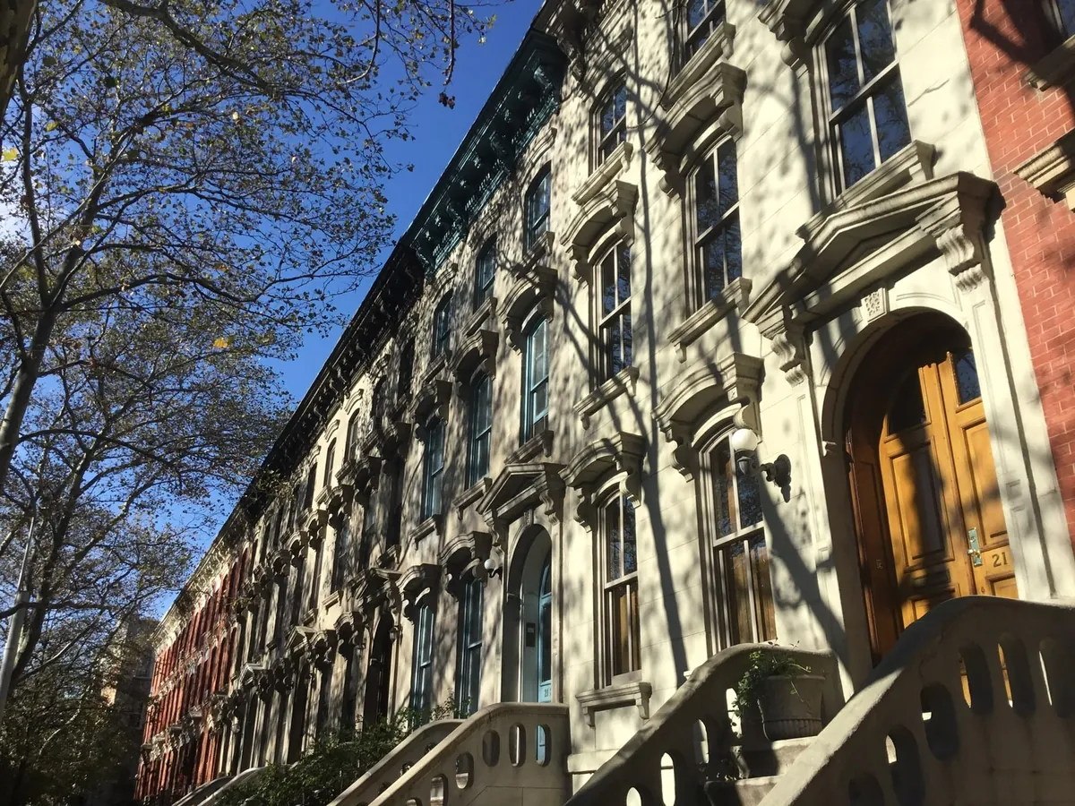 Historic stone-front townhouses and stoops on 45th Avenue near Court Square in Long Island City
