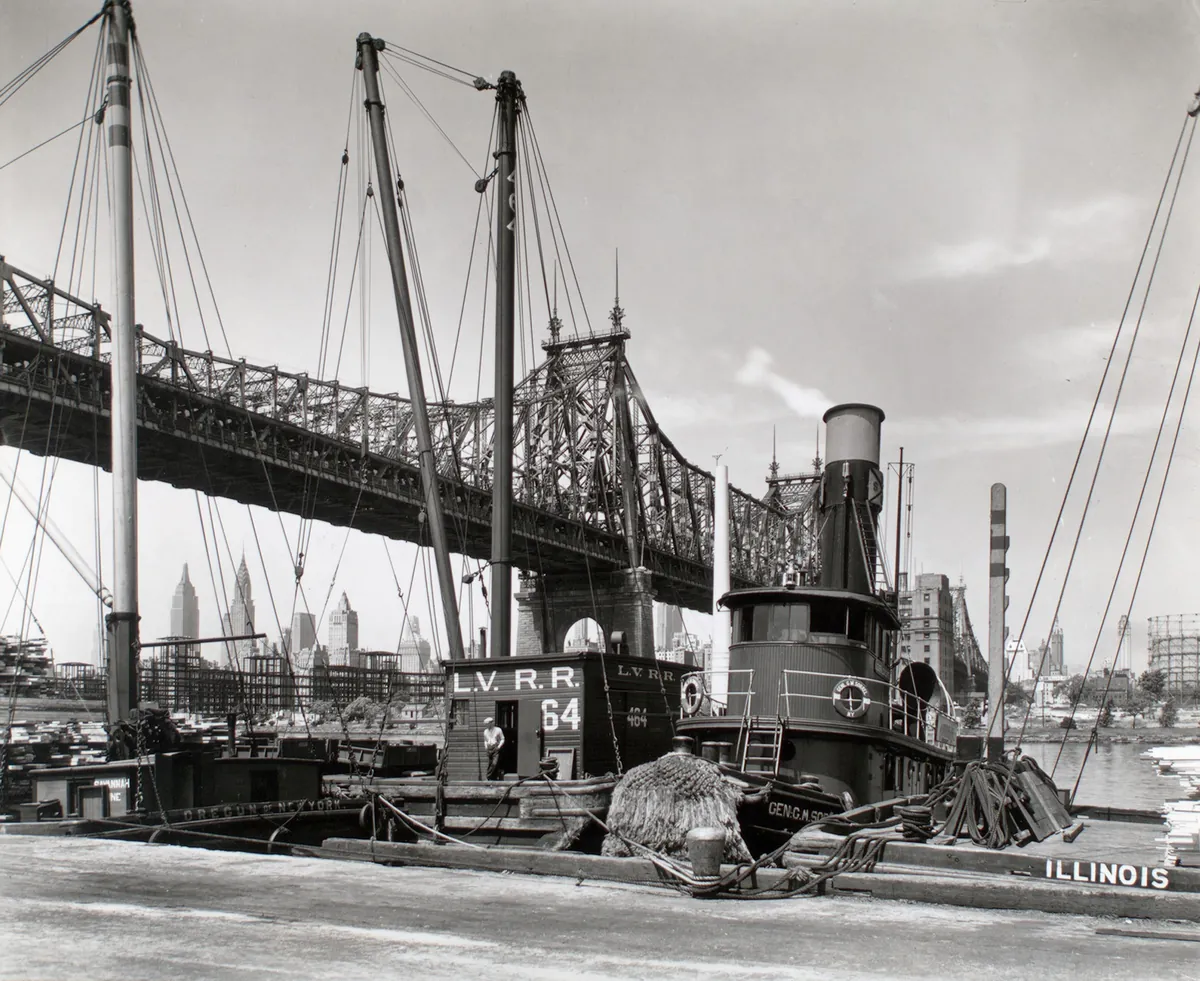 Tugboats and barges beneath the Queensboro Bridge, seen from the pier at 41st Road in Long Island City in 1937