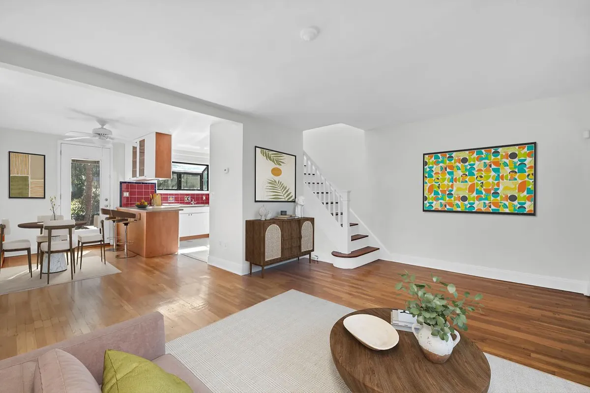 Living and dining spaces, kitchen and staircase at 39-39 46th Street